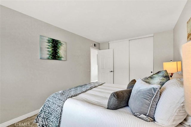 bedroom featuring carpet and a closet