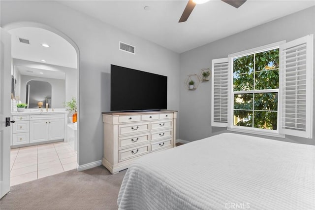 carpeted bedroom featuring ceiling fan, connected bathroom, and sink