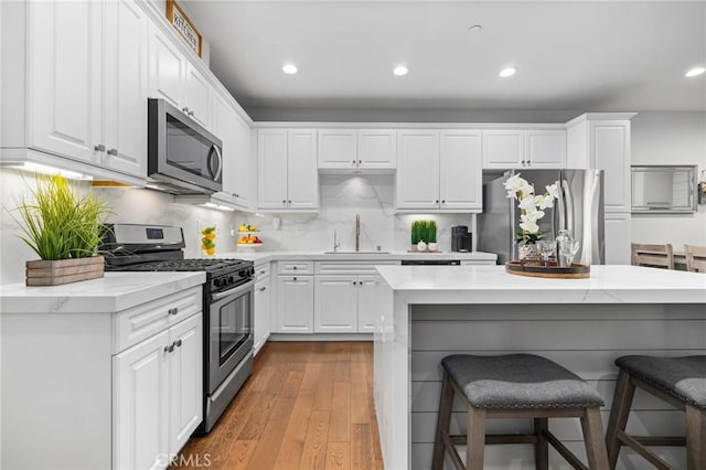 kitchen featuring white cabinetry, sink, and appliances with stainless steel finishes