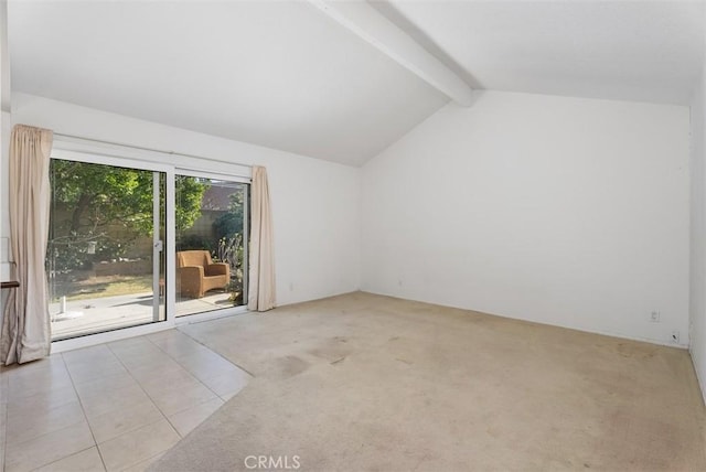 empty room featuring lofted ceiling with beams and light carpet