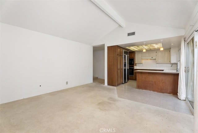 kitchen featuring light colored carpet, oven, lofted ceiling with beams, and decorative backsplash