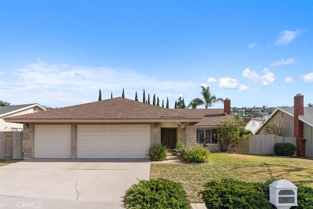 single story home featuring a garage and a front lawn