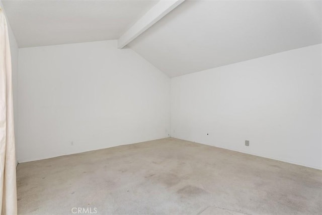 bonus room featuring lofted ceiling with beams and light carpet