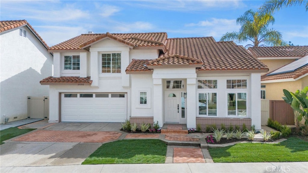 mediterranean / spanish house featuring a garage