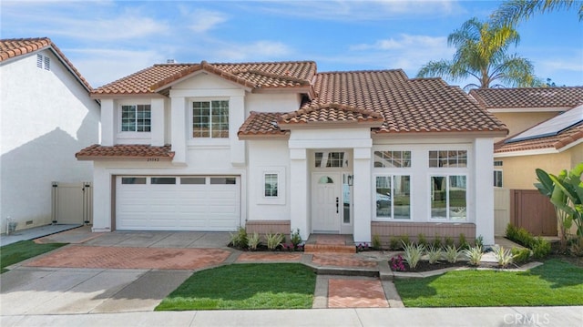 mediterranean / spanish house featuring a garage