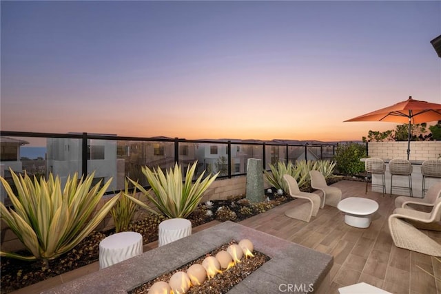 patio terrace at dusk with an outdoor fire pit