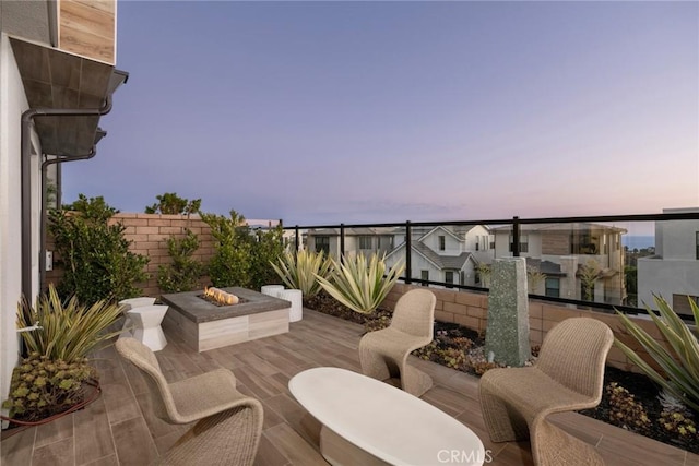 patio terrace at dusk with an outdoor fire pit