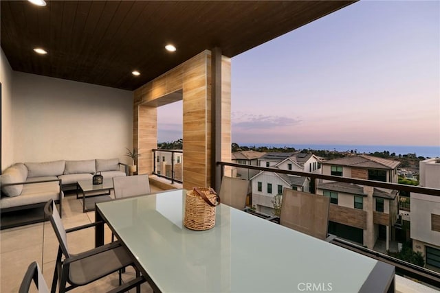 balcony at dusk with an outdoor hangout area