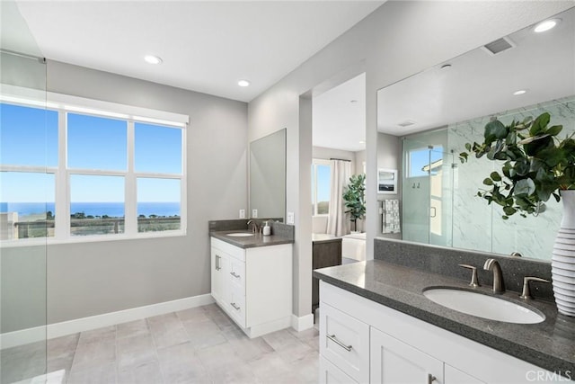 bathroom with an enclosed shower, vanity, and a water view