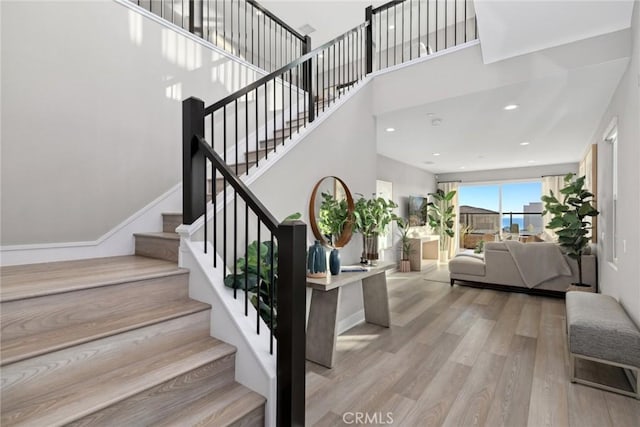 staircase with hardwood / wood-style flooring