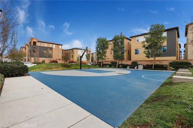 view of basketball court with a yard