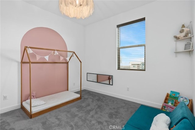 bedroom featuring an inviting chandelier and carpet