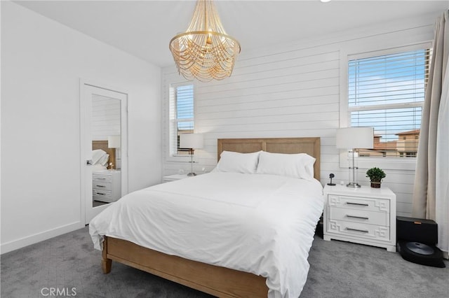 carpeted bedroom with an inviting chandelier