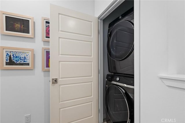 laundry room with stacked washer / drying machine