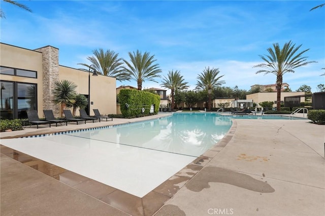 view of swimming pool with a patio