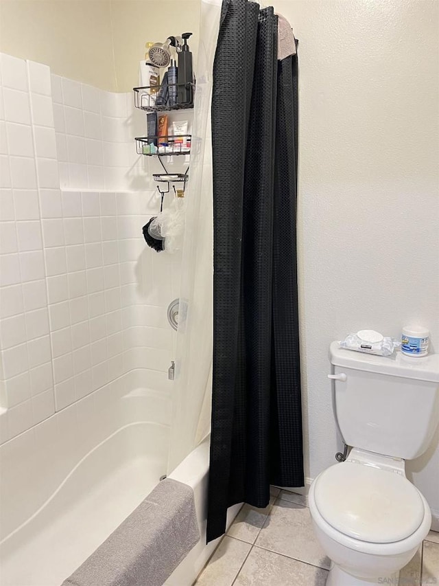 bathroom featuring shower / tub combo, toilet, and tile patterned flooring