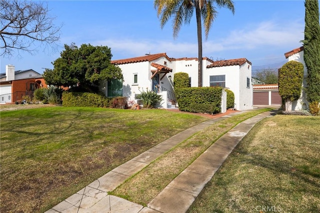 mediterranean / spanish home with a front lawn