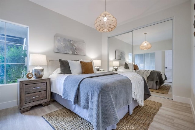 bedroom featuring a closet and light hardwood / wood-style flooring