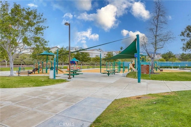 view of property's community with a yard and a playground