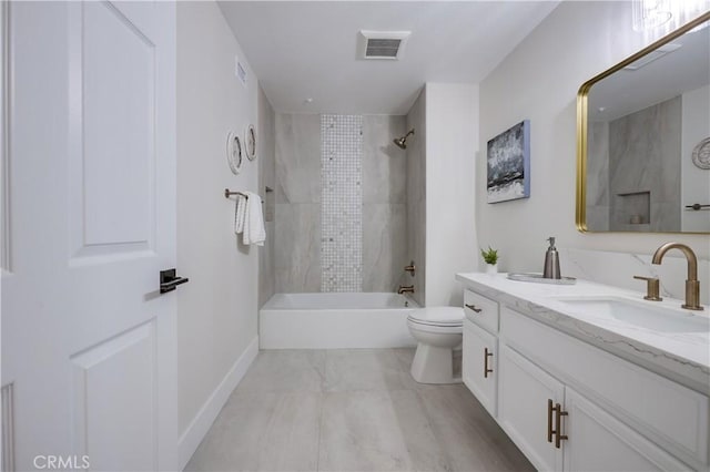 full bathroom with vanity, toilet, and tiled shower / bath combo