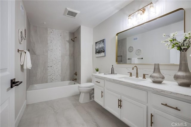 full bathroom featuring tiled shower / bath combo, vanity, and toilet