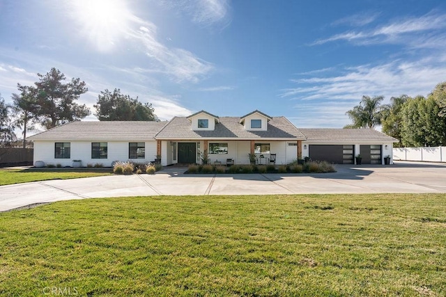 view of front of property featuring a garage and a front yard