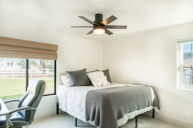 bedroom with ceiling fan and light carpet