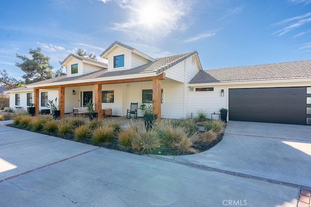 view of front of home featuring a garage and a porch