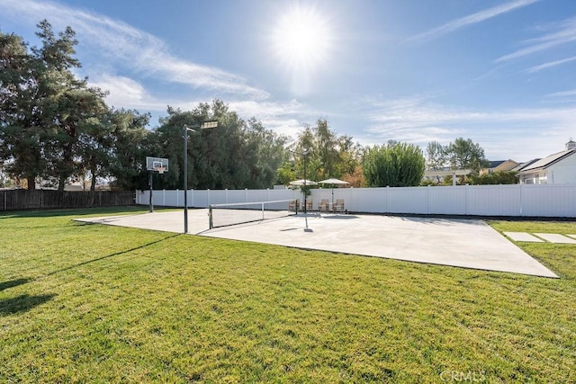 view of basketball court featuring a yard