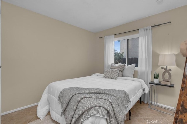 bedroom with light tile patterned floors