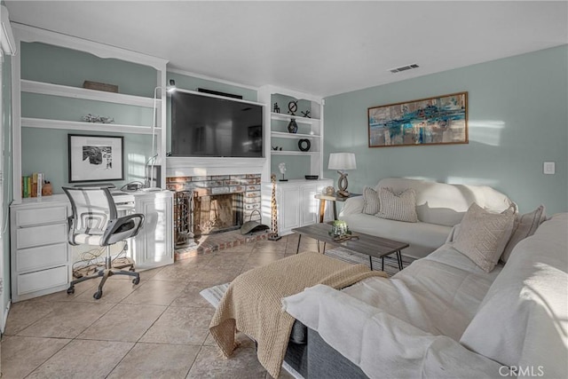 living room with light tile patterned floors, a fireplace, and built in features