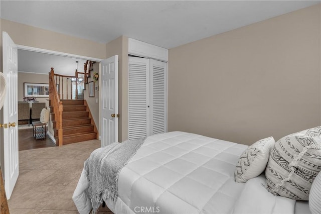 bedroom with light tile patterned floors and a closet