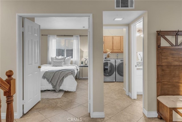 tiled bedroom with washer and dryer