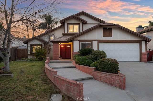 view of front of property featuring a garage and a lawn