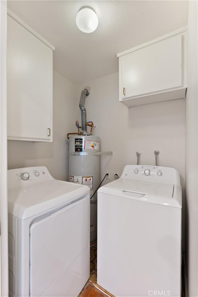 laundry room with separate washer and dryer, strapped water heater, and cabinets