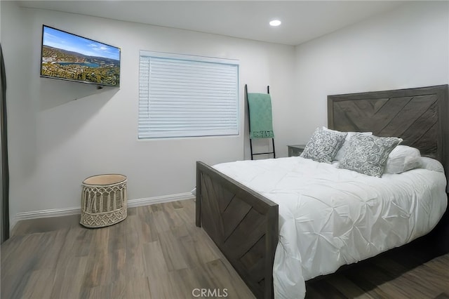 bedroom with wood-type flooring