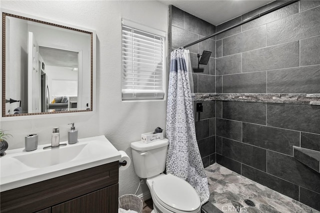 bathroom featuring walk in shower, vanity, and toilet