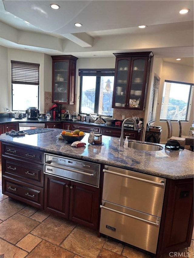 kitchen featuring tasteful backsplash, sink, and dark brown cabinetry