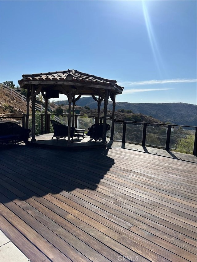 dock area with a gazebo and a deck with mountain view