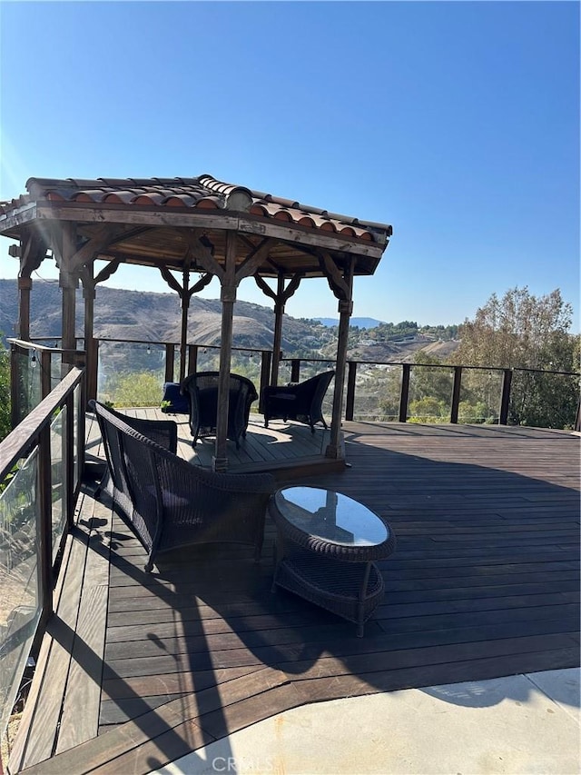 wooden deck featuring a mountain view