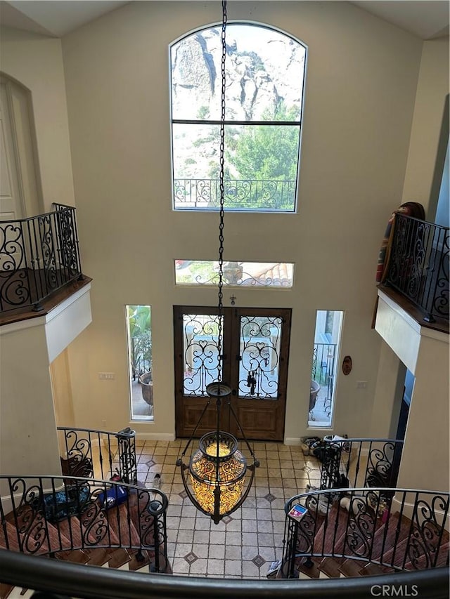 foyer entrance with a towering ceiling