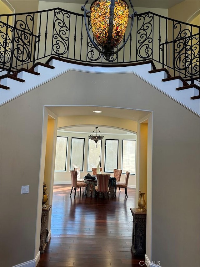 dining space featuring wood-type flooring and a notable chandelier