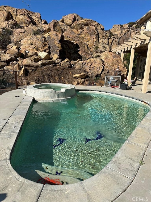 view of pool with an in ground hot tub