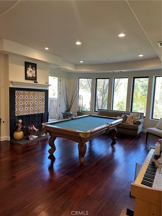 game room with a tile fireplace, dark hardwood / wood-style flooring, and billiards