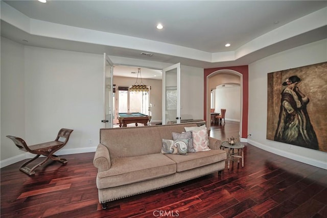 living room featuring pool table, a tray ceiling, and hardwood / wood-style floors