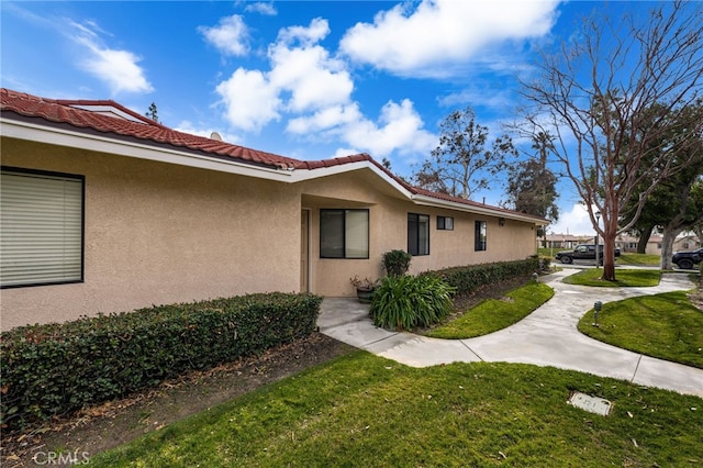 view of property exterior featuring a lawn