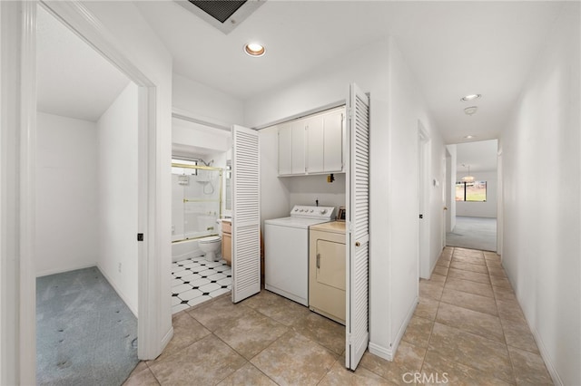 laundry area featuring independent washer and dryer and cabinets