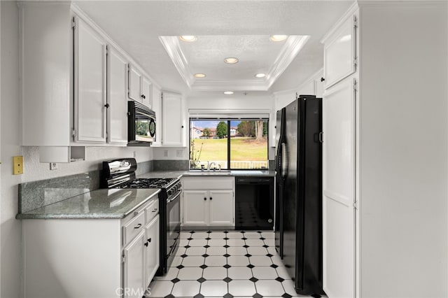 kitchen featuring sink, black appliances, ornamental molding, a raised ceiling, and white cabinets