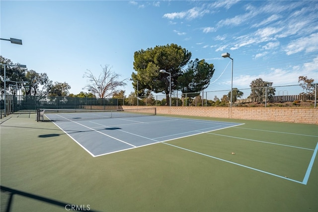 view of tennis court featuring basketball court