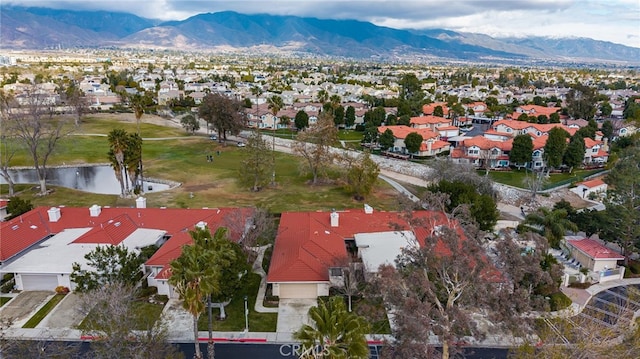 birds eye view of property featuring a water and mountain view